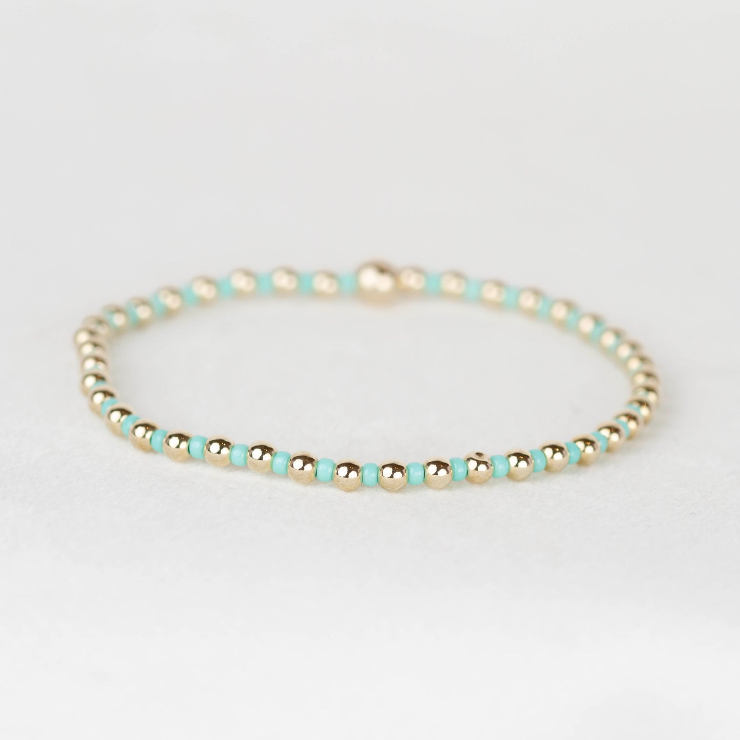 Aqua blue green  Bella seed bead alternating with 14k gold filled or sterling silver beaded stretch bracelet 
