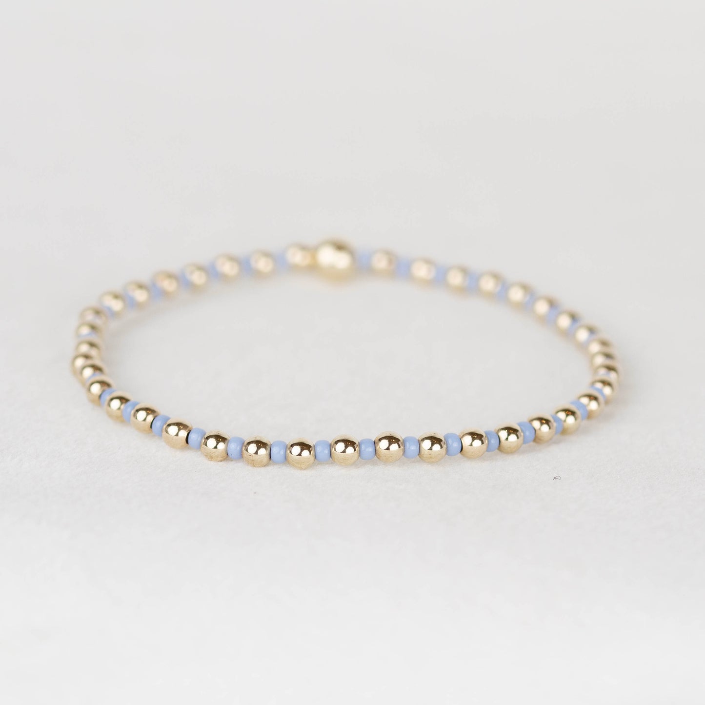 Carolina light blue Bella seed bead alternating with 14k gold filled or sterling silver beaded stretch bracelet 
