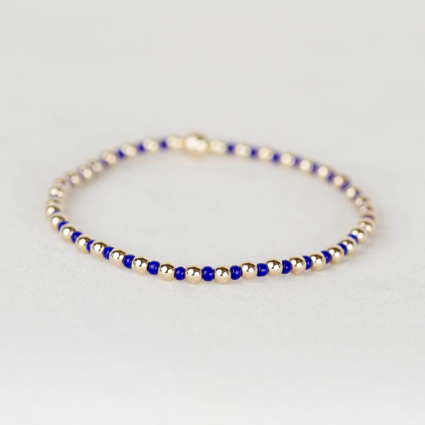 Cobalt blue Bella seed bead alternating with 14k gold filled or sterling silver beaded stretch bracelet 
