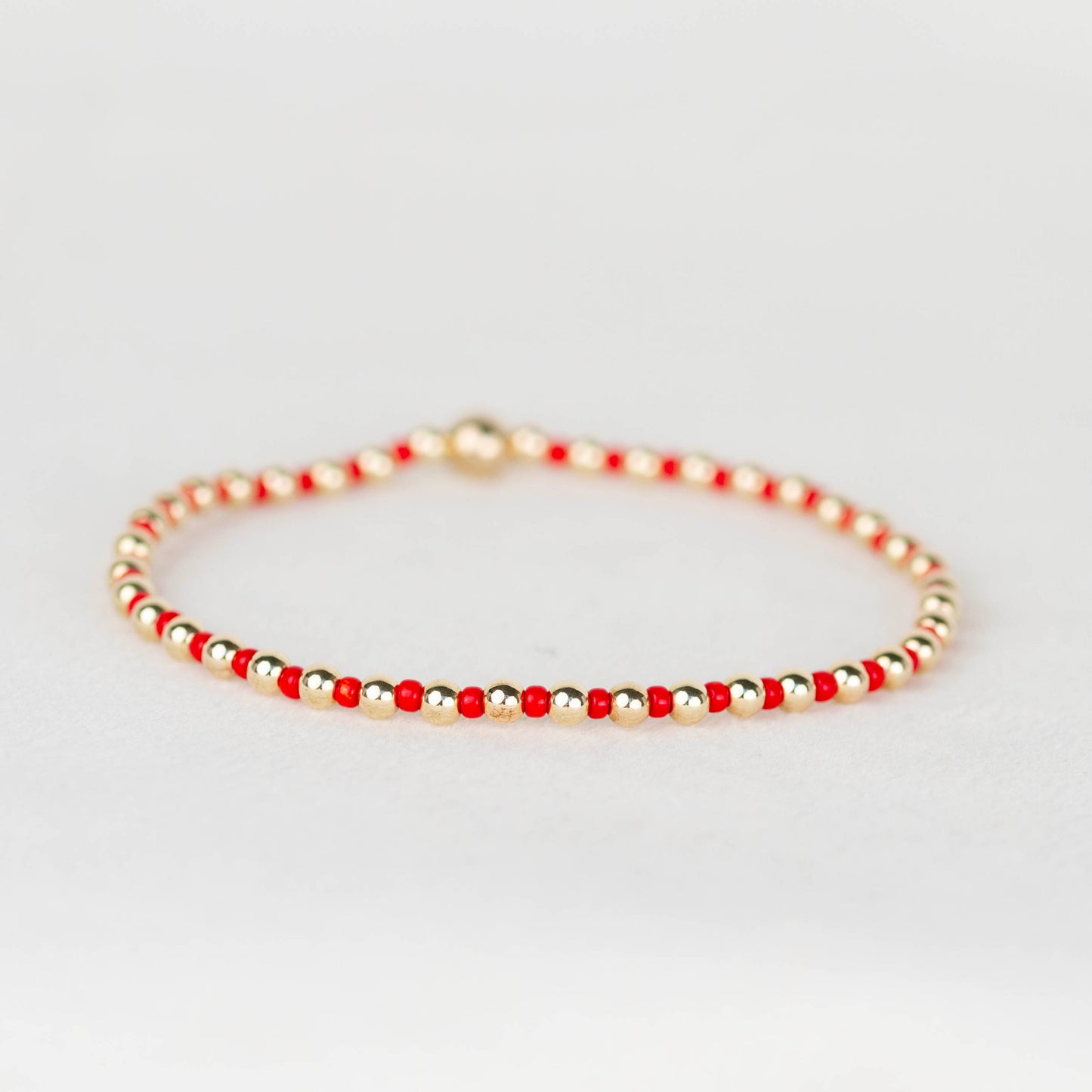 Red Bella seed bead alternating with 14k gold filled or sterling silver beaded stretch bracelet 