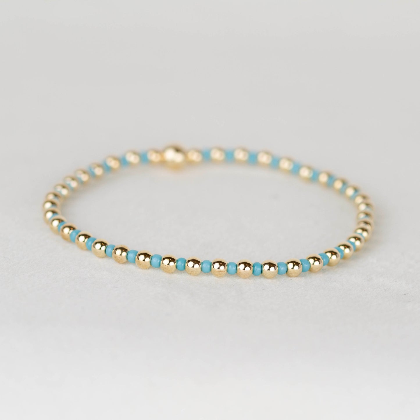 blue Bella seed bead alternating with 14k gold filled or sterling silver beaded stretch bracelet 