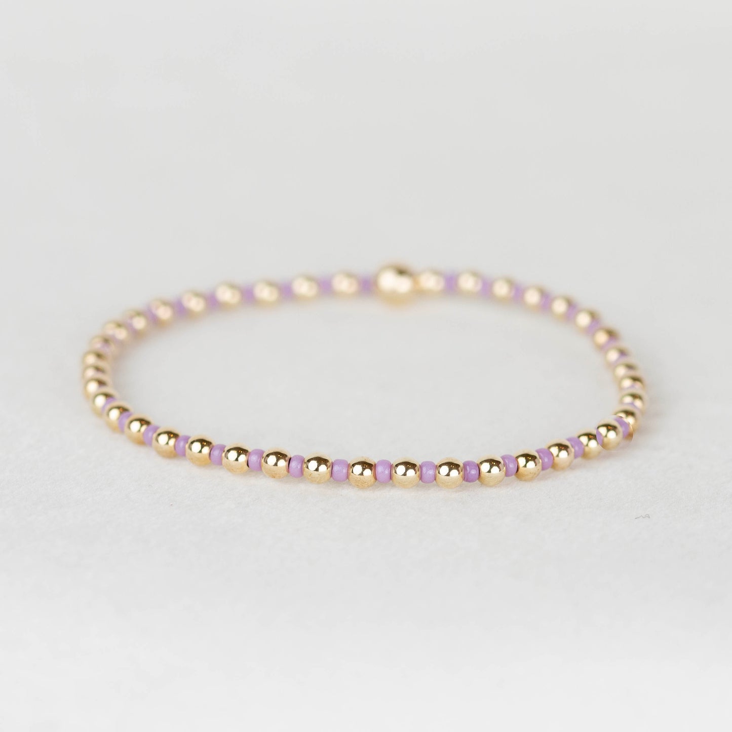 Dusty lavender purple Bella seed bead alternating with 14k gold filled or sterling silver beaded stretch bracelet 
