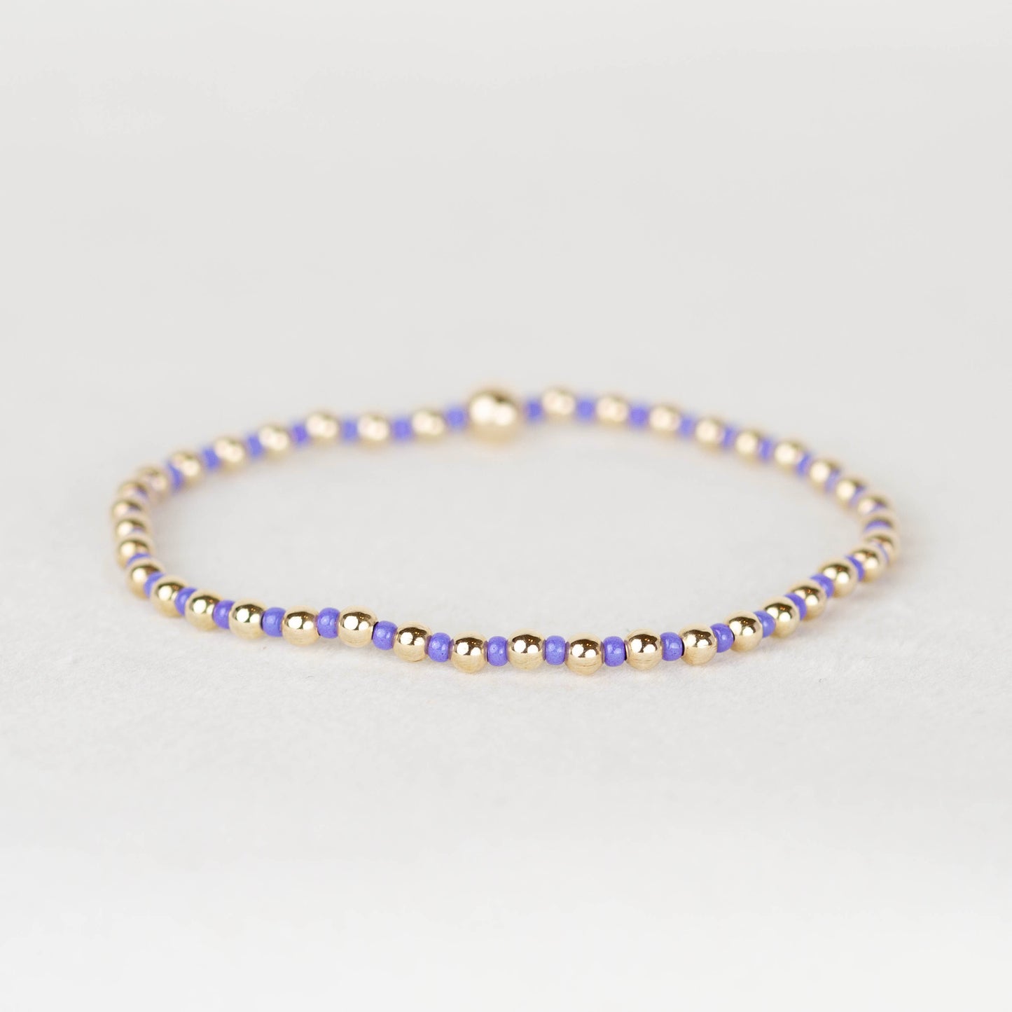 Purple blue Bella seed bead alternating with 14k gold filled or sterling silver beaded stretch bracelet 
