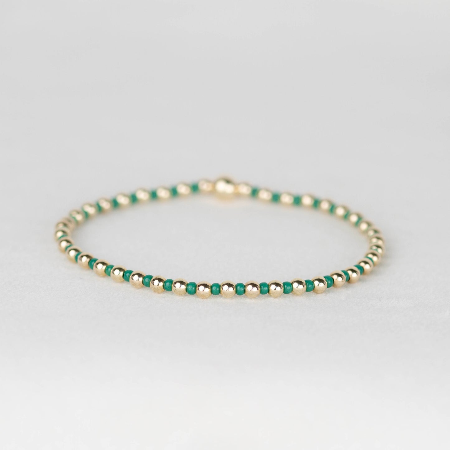 Jade Kelly green Bella seed bead alternating with 14k gold filled or sterling silver beaded stretch bracelet 
