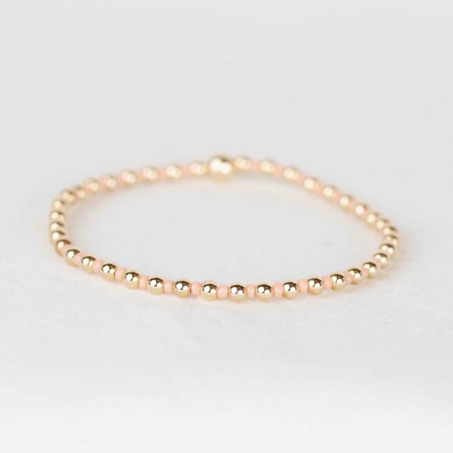 Peach Bella seed bead alternating with 14k gold filled or sterling silver beaded stretch bracelet 