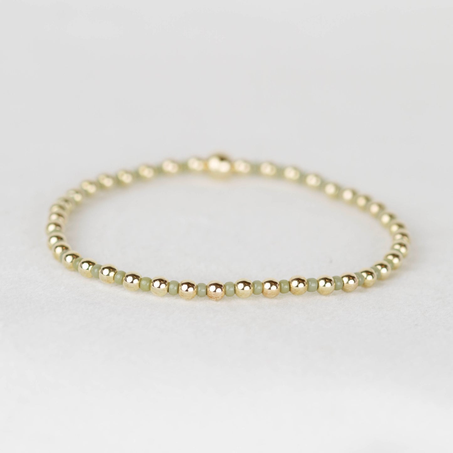 Sage green Bella seed bead alternating with 14k gold filled or sterling silver beaded stretch bracelet 
