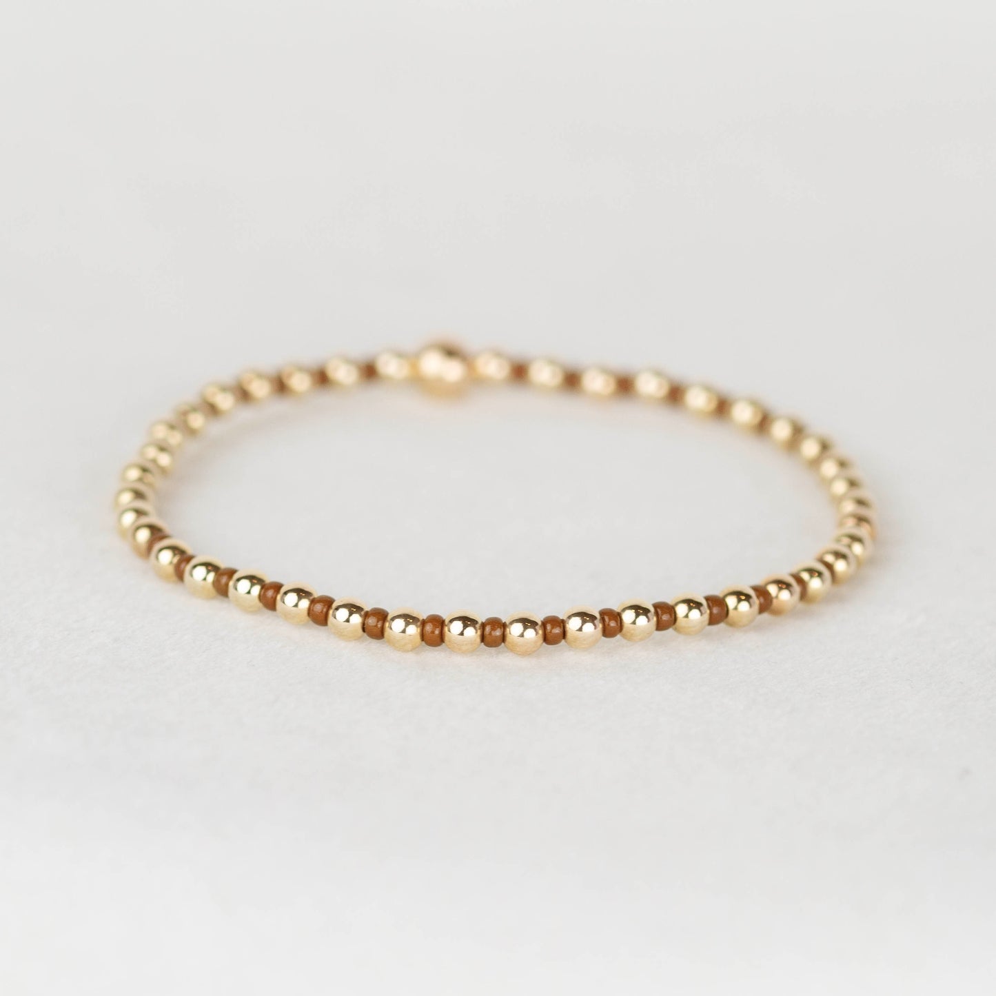 Brown Bella seed bead alternating with 14k gold filled or sterling silver beaded stretch bracelet