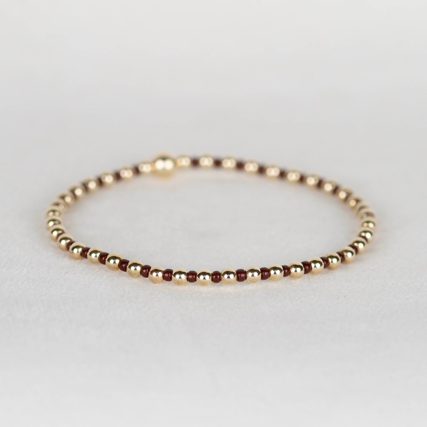 Dark brown Bella seed bead alternating with 14k gold filled or sterling silver beaded stretch bracelet