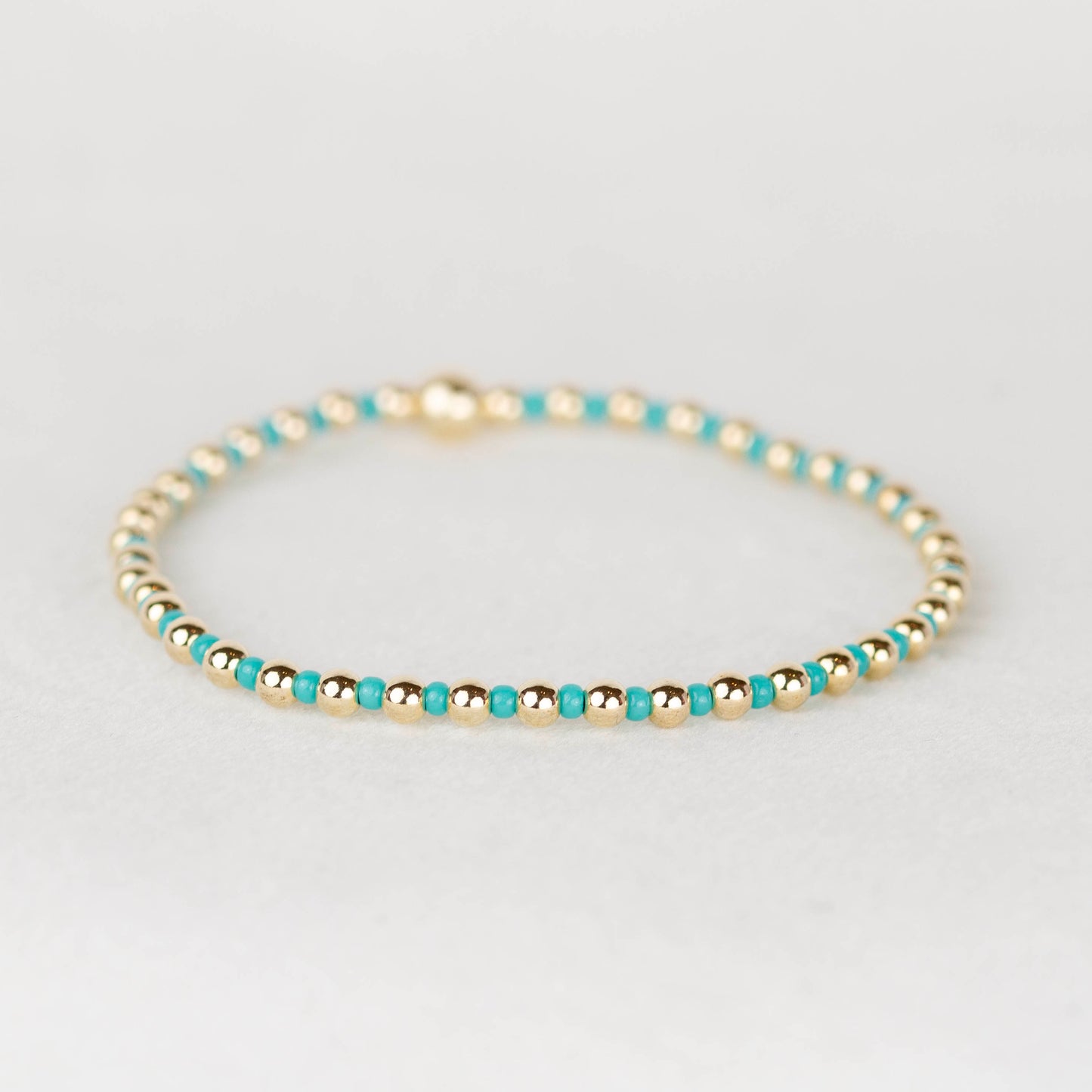 Turquoise green blue Bella seed bead alternating with 14k gold filled or sterling silver beaded stretch bracelet 
