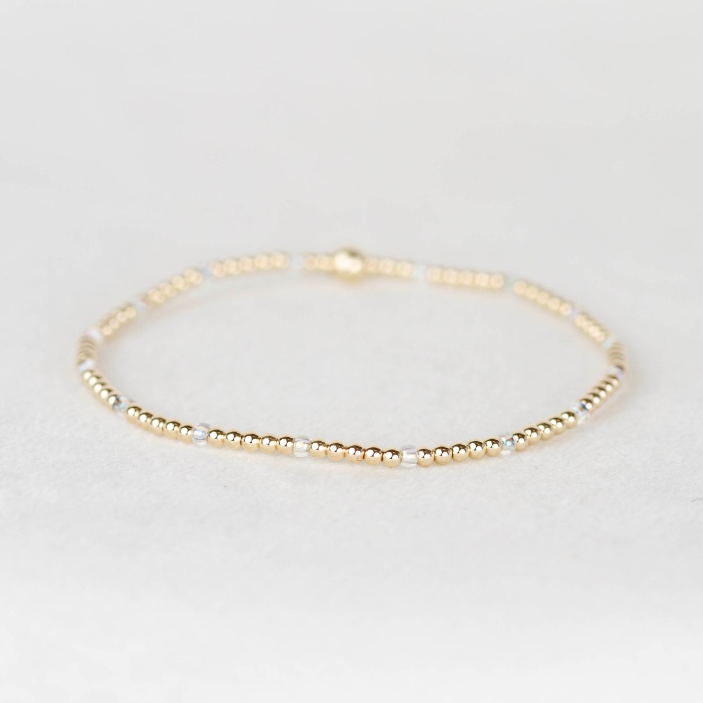 Clear iridescent Chloe seed bead bracelet with 14k gold filled or sterling silver beaded stretch bracelet 
