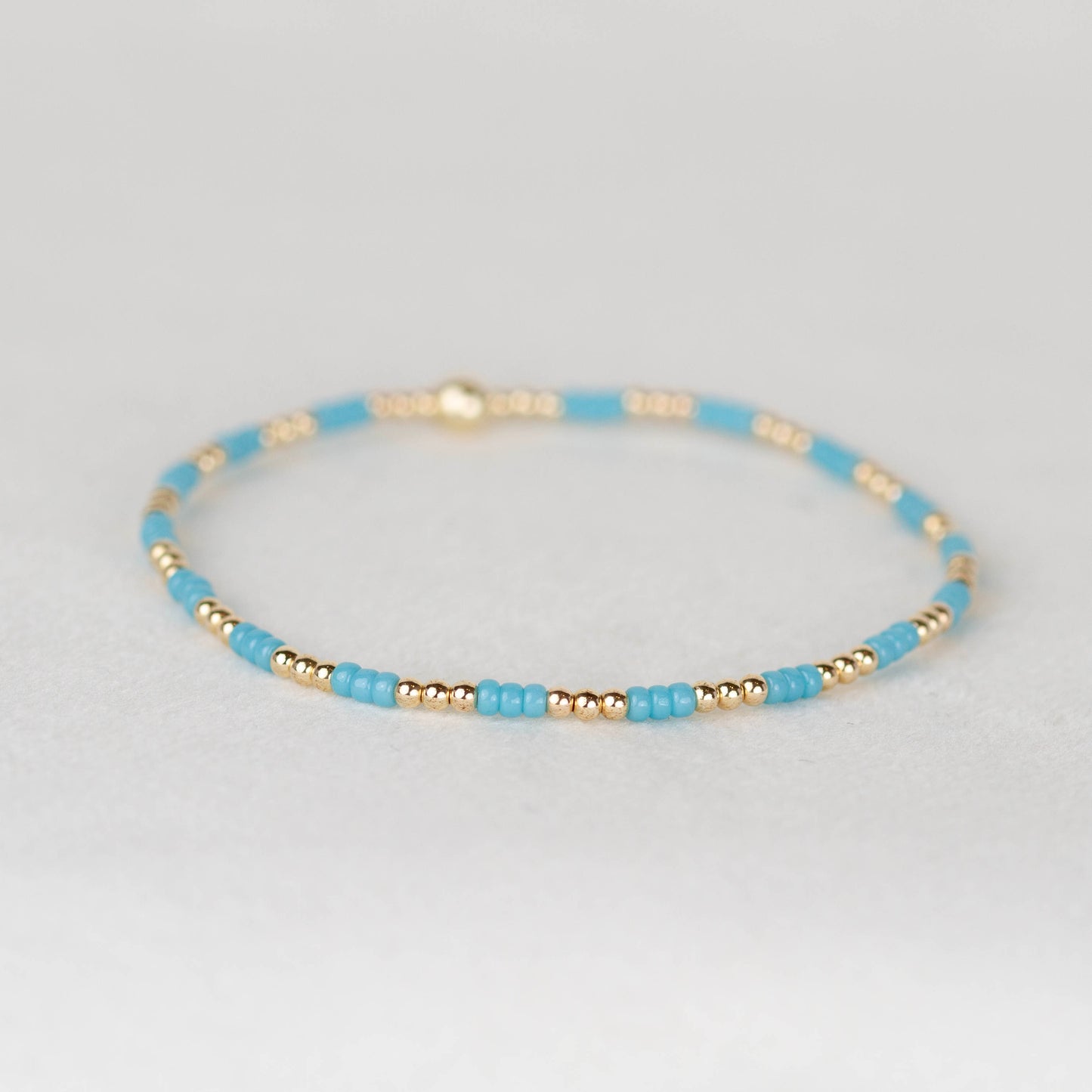 blue Madi seed bead alternating with 14k gold filled or sterling silver beaded stretch bracelet 