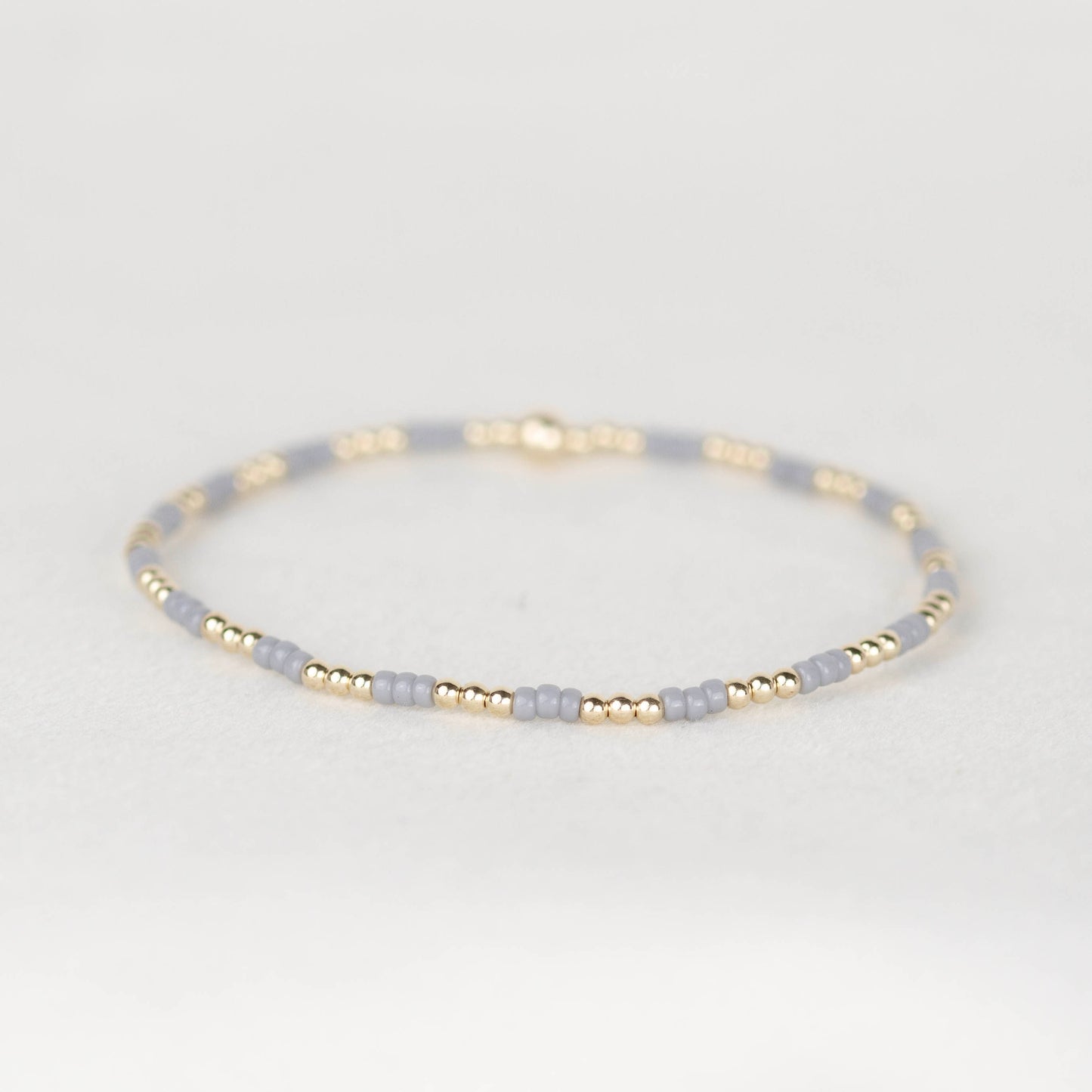 light gray Madi seed bead bracelet with 14k gold filled or sterling silver beaded stretch bracelet