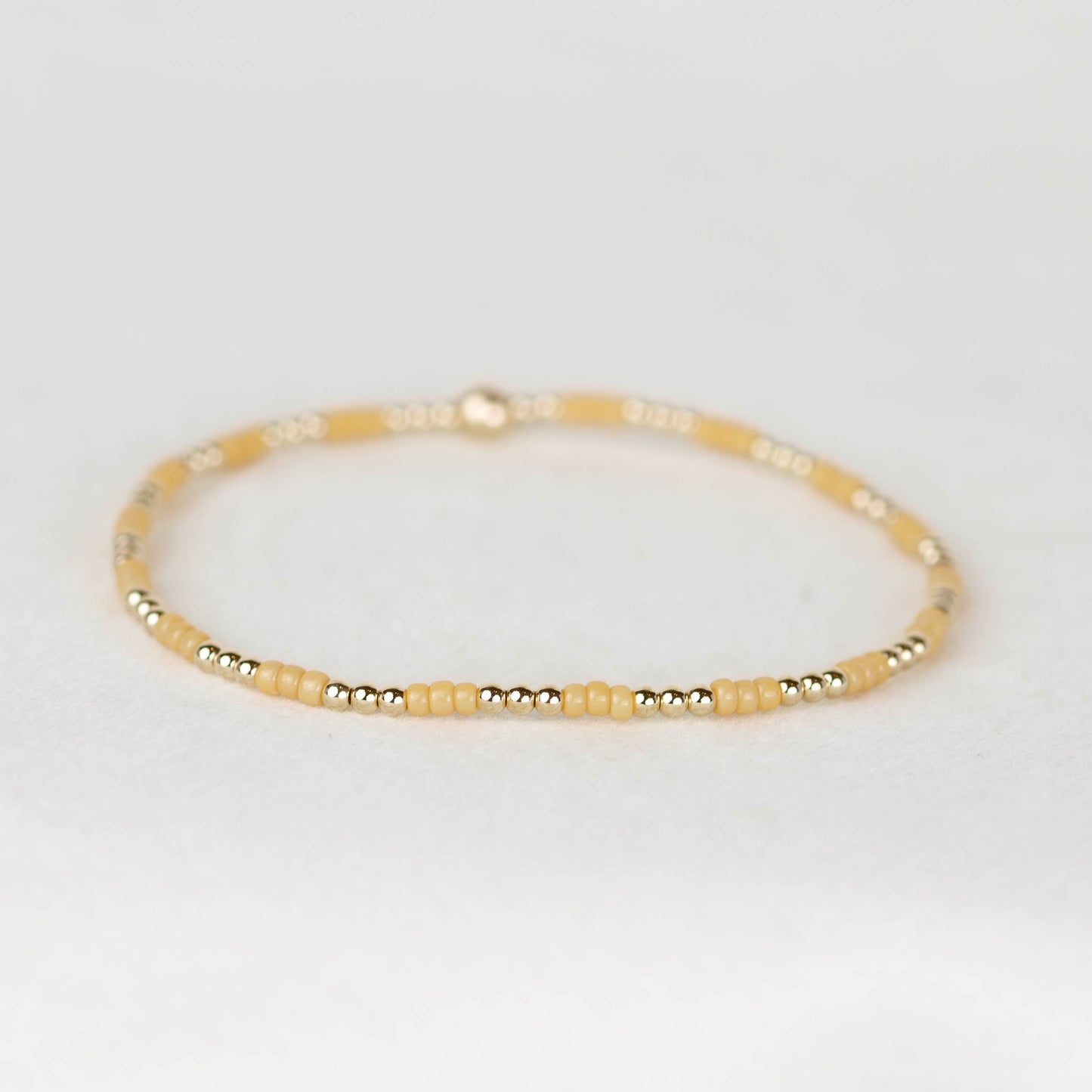 Golden yellow tan Madi seed bead alternating with 14k gold filled or sterling silver beaded stretch bracelet 