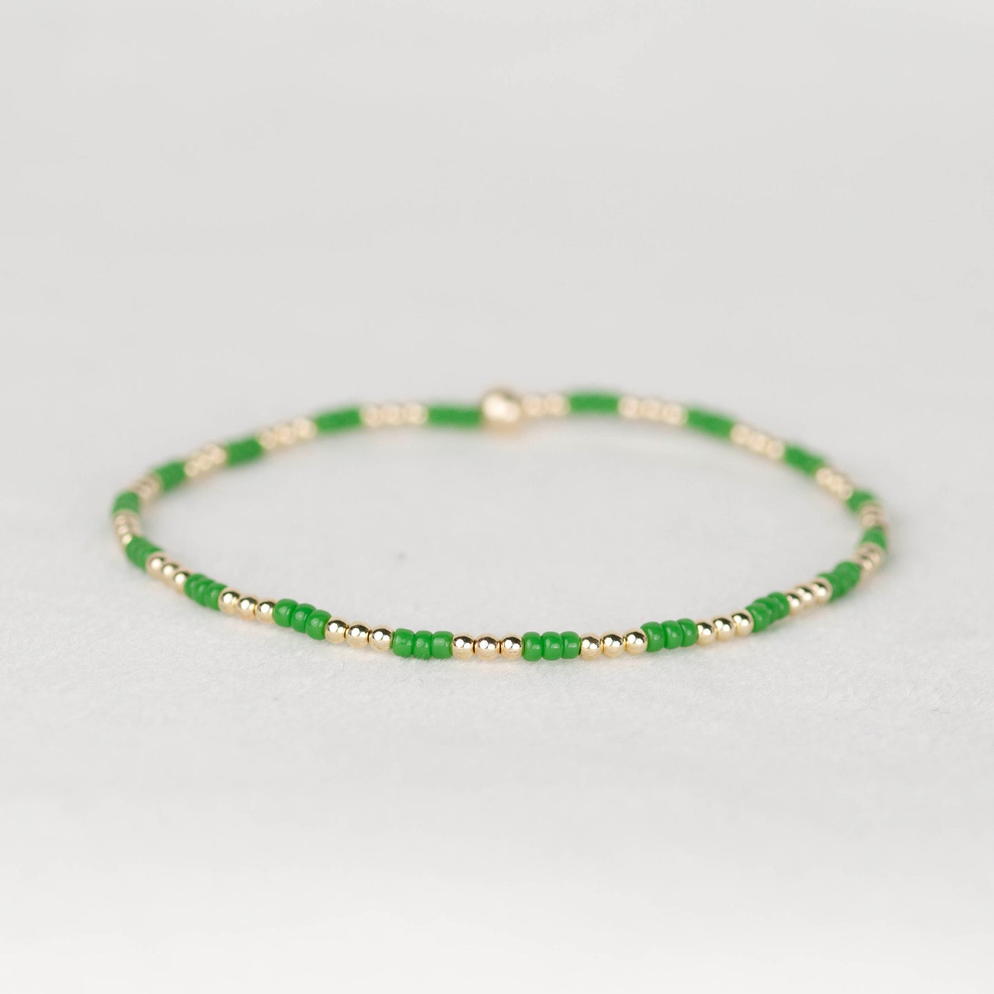 Green Madi seed bead alternating with 14k gold filled or sterling silver beaded stretch bracelet 