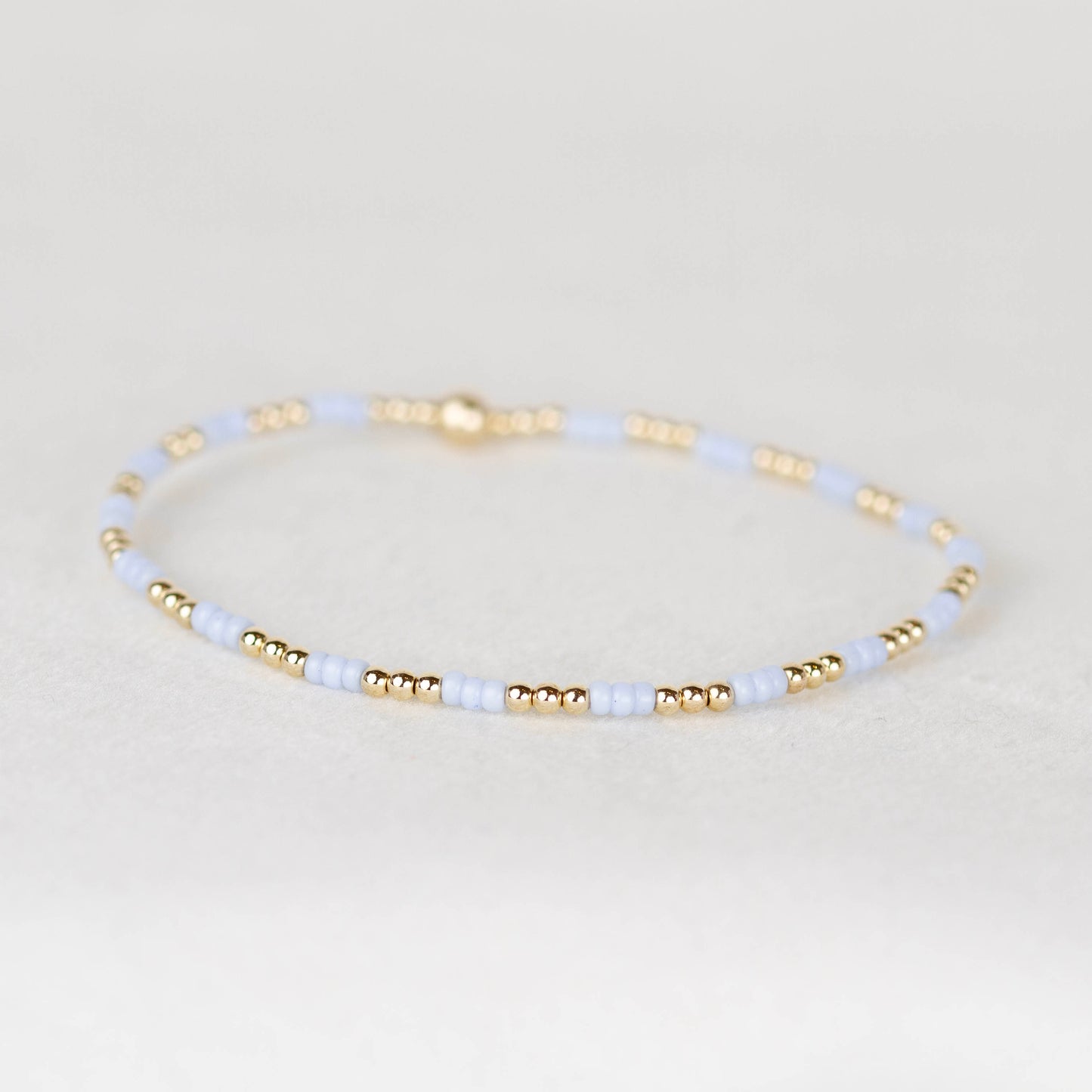 Light pale blue Madi seed bead alternating with 14k gold filled or sterling silver beaded stretch bracelet 
