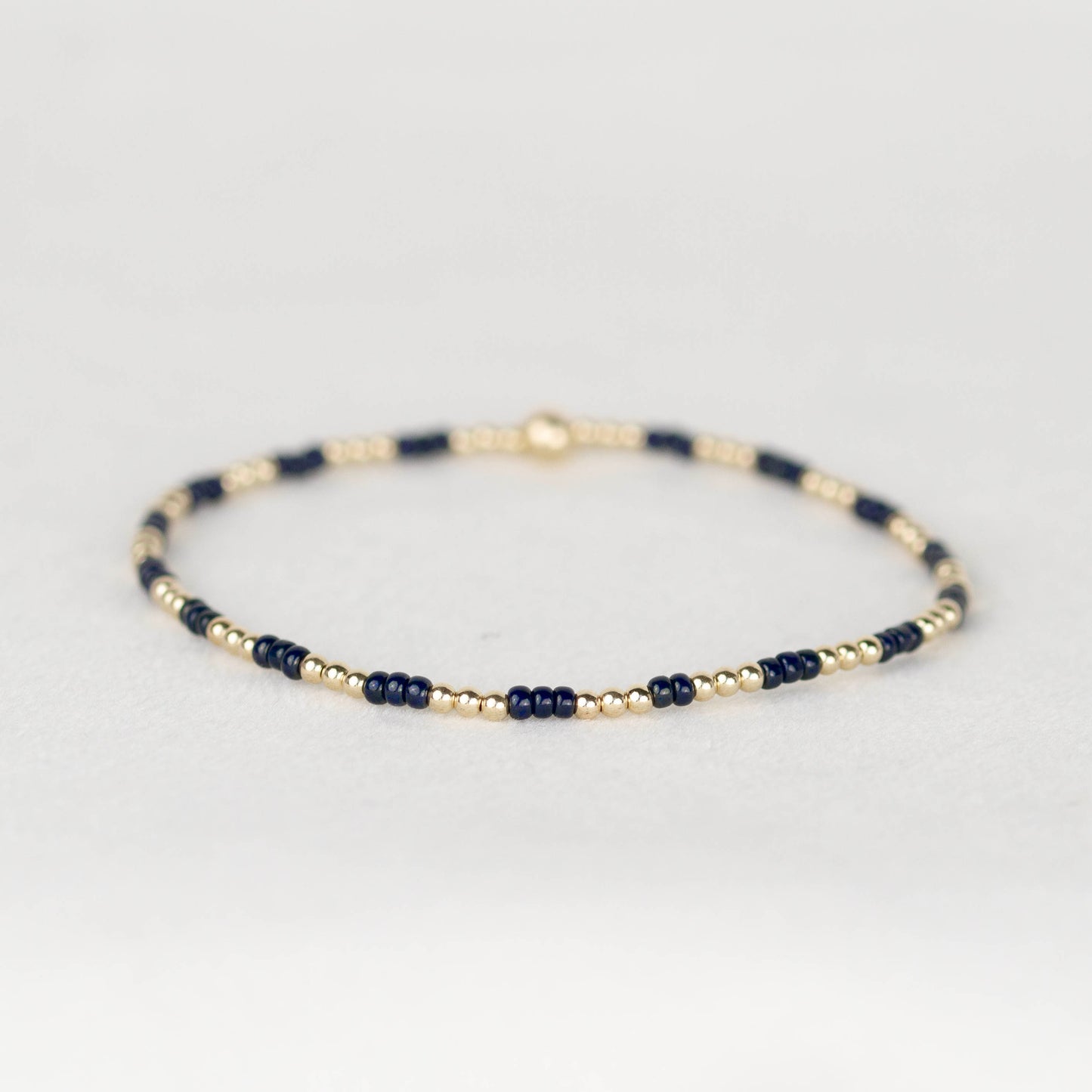 Dark midnight navy blue Madi seed bead alternating with 14k gold filled or sterling silver beaded stretch bracelet 