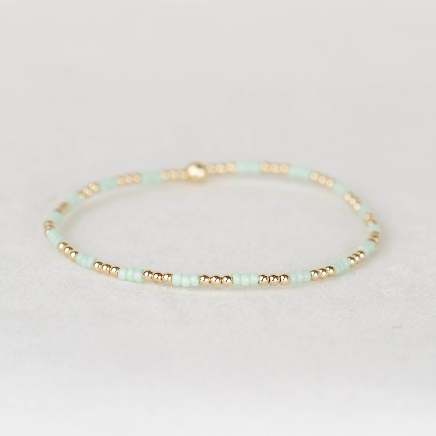 mint green Madi seed bead alternating with 14k gold filled or sterling silver beaded stretch bracelet 