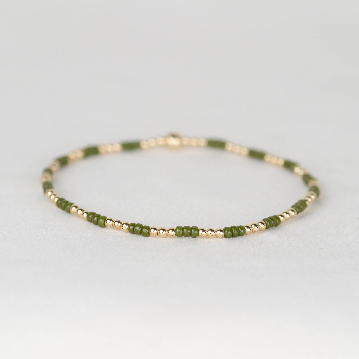 Moss dark green Madi seed bead alternating with 14k gold filled or sterling silver beaded stretch bracelet 
