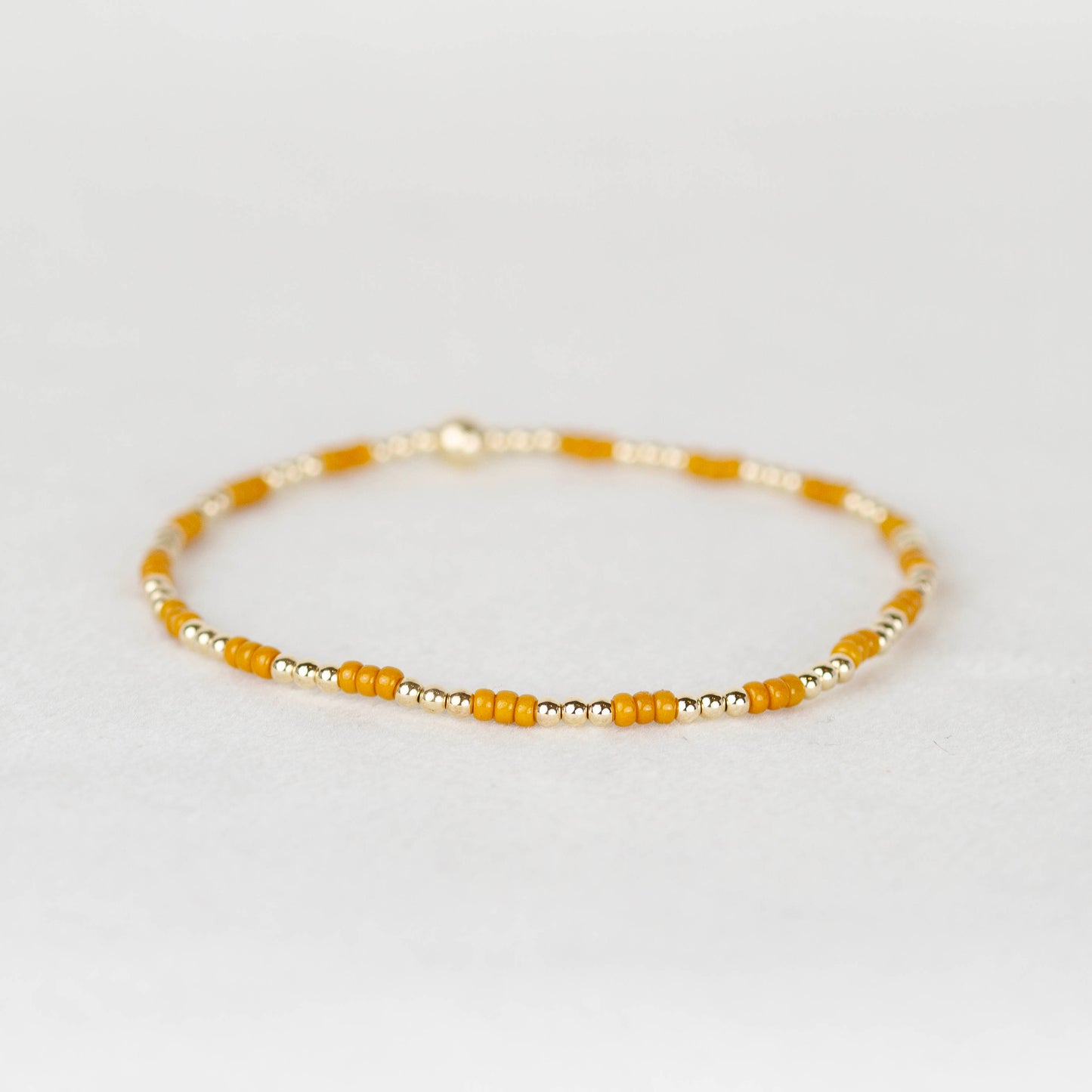 Mustard yellow Madi seed bead alternating with 14k gold filled or sterling silver beaded stretch bracelet 
