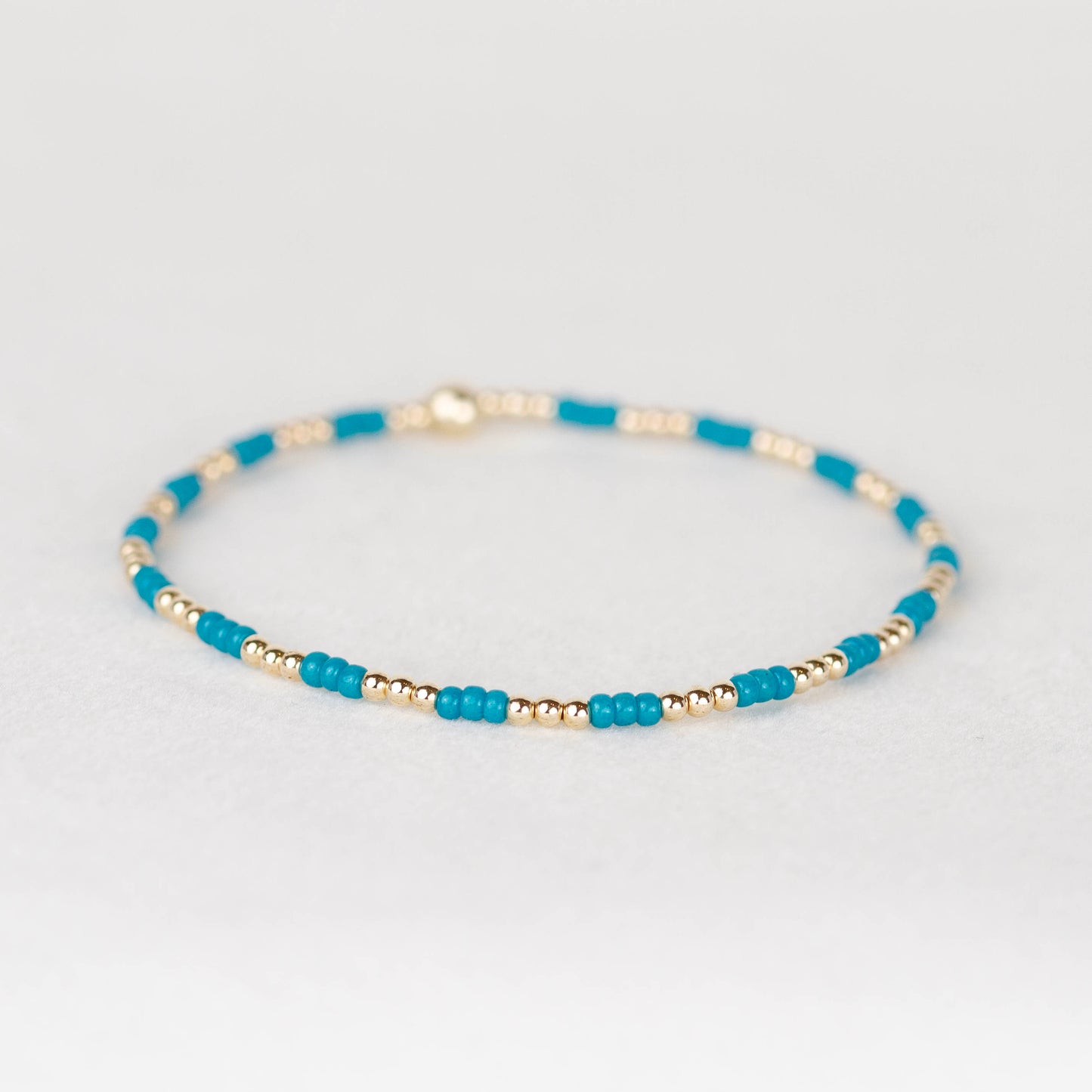 Peacock teal blue Madi seed bead alternating with 14k gold filled or sterling silver beaded stretch bracelet 