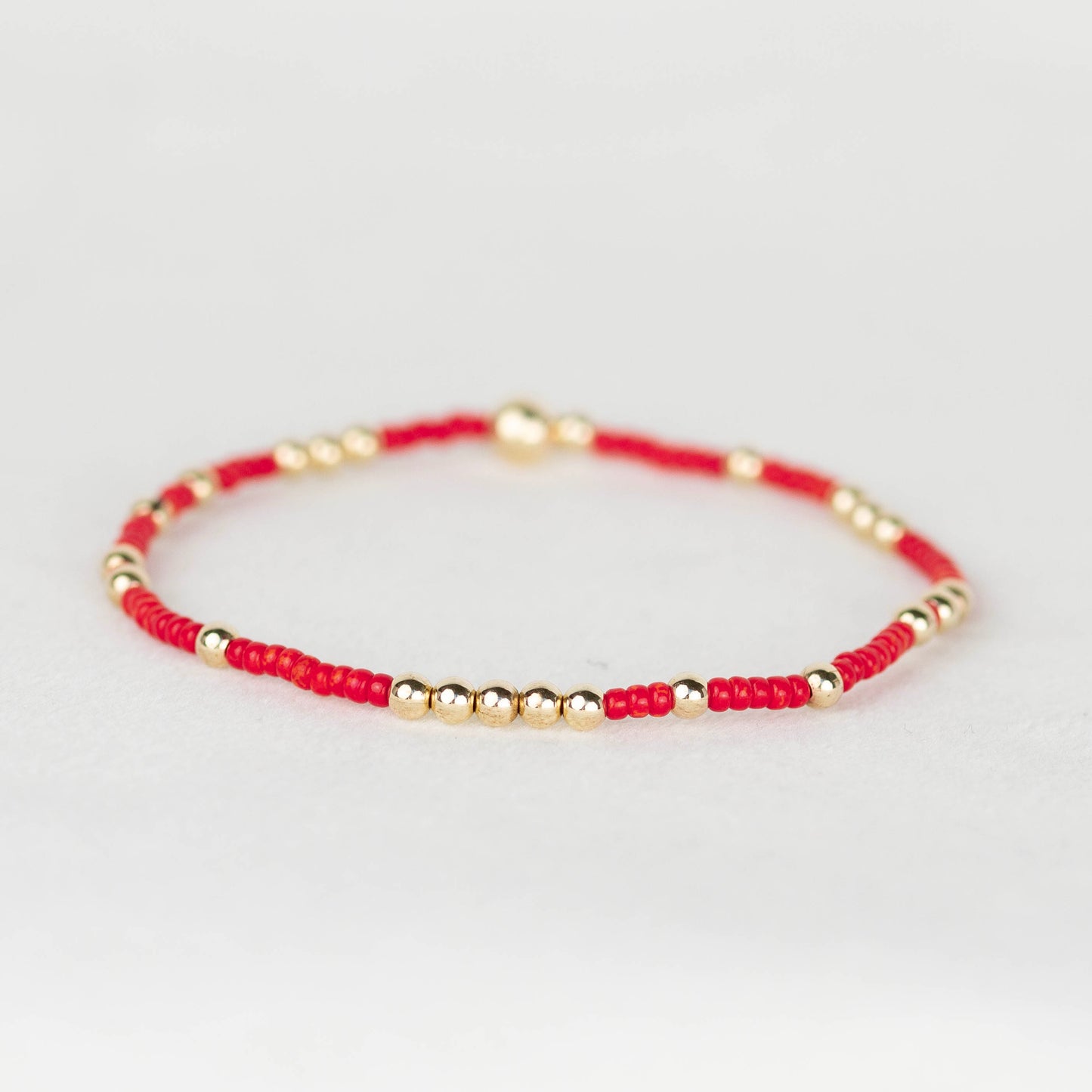 Red Olivia seed bead with scattered 14k gold filled or sterling silver beaded stretch bracelet 