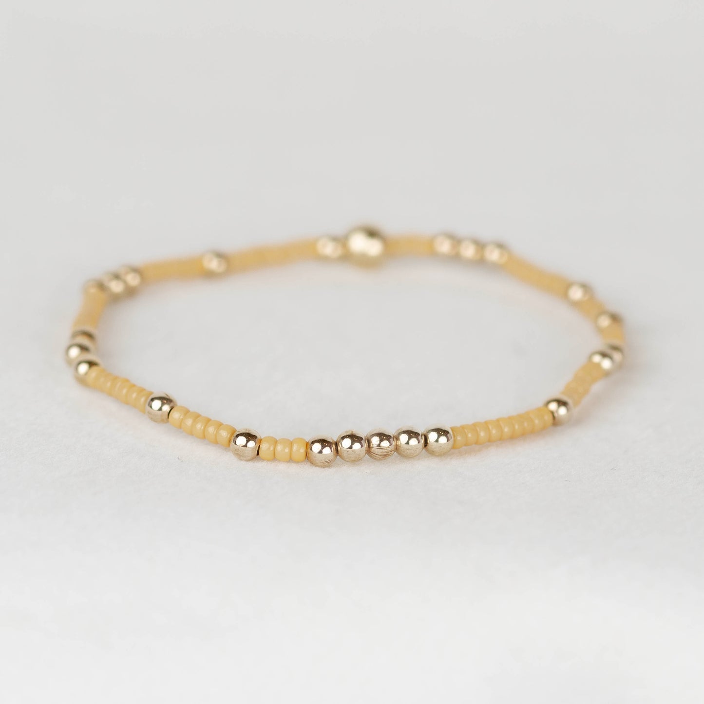Golden yellow Olivia seed bead with scattered 14k gold filled or sterling silver beaded stretch bracelet 