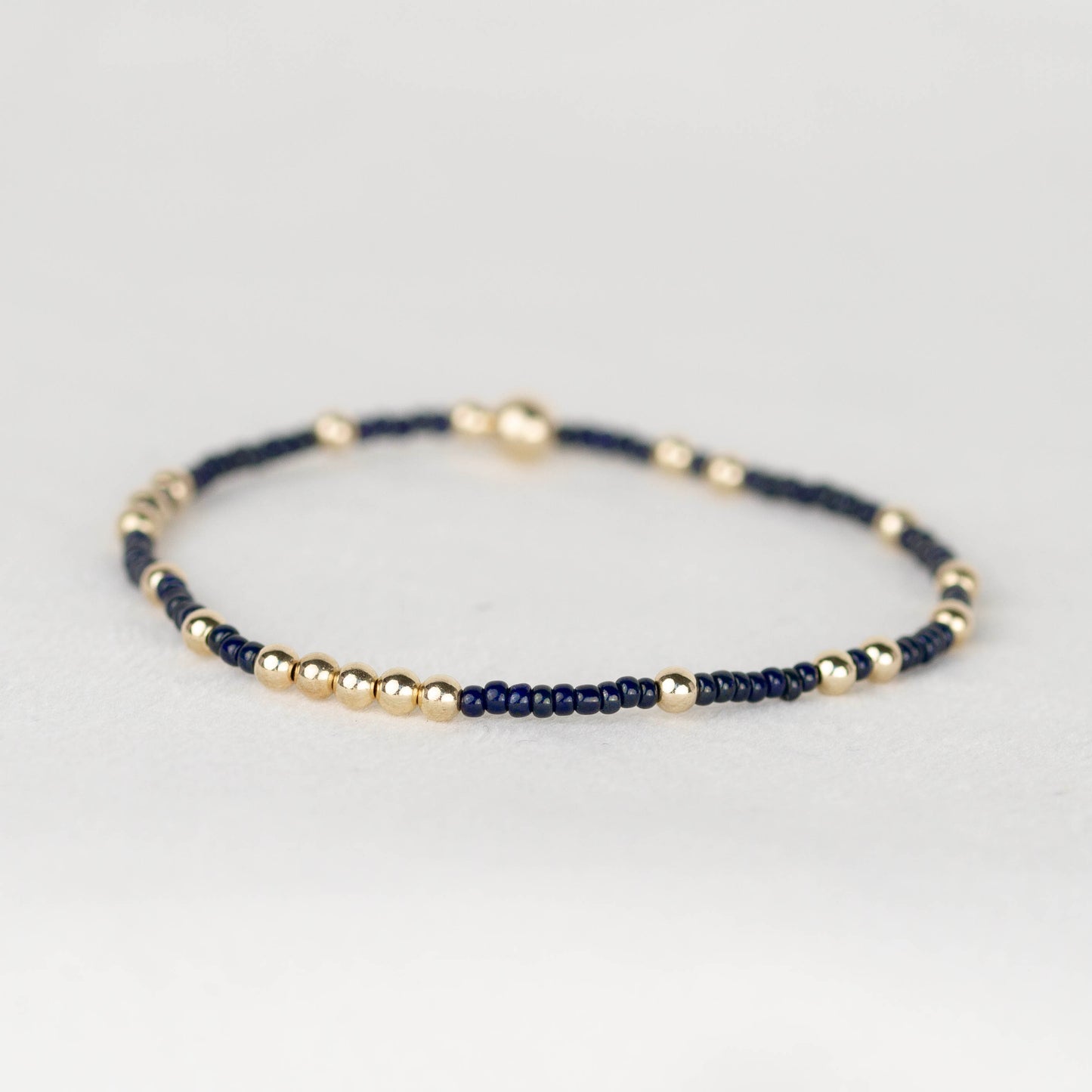Dark navy Olivia seed bead with scattered 14k gold filled or sterling silver beaded stretch bracelet 