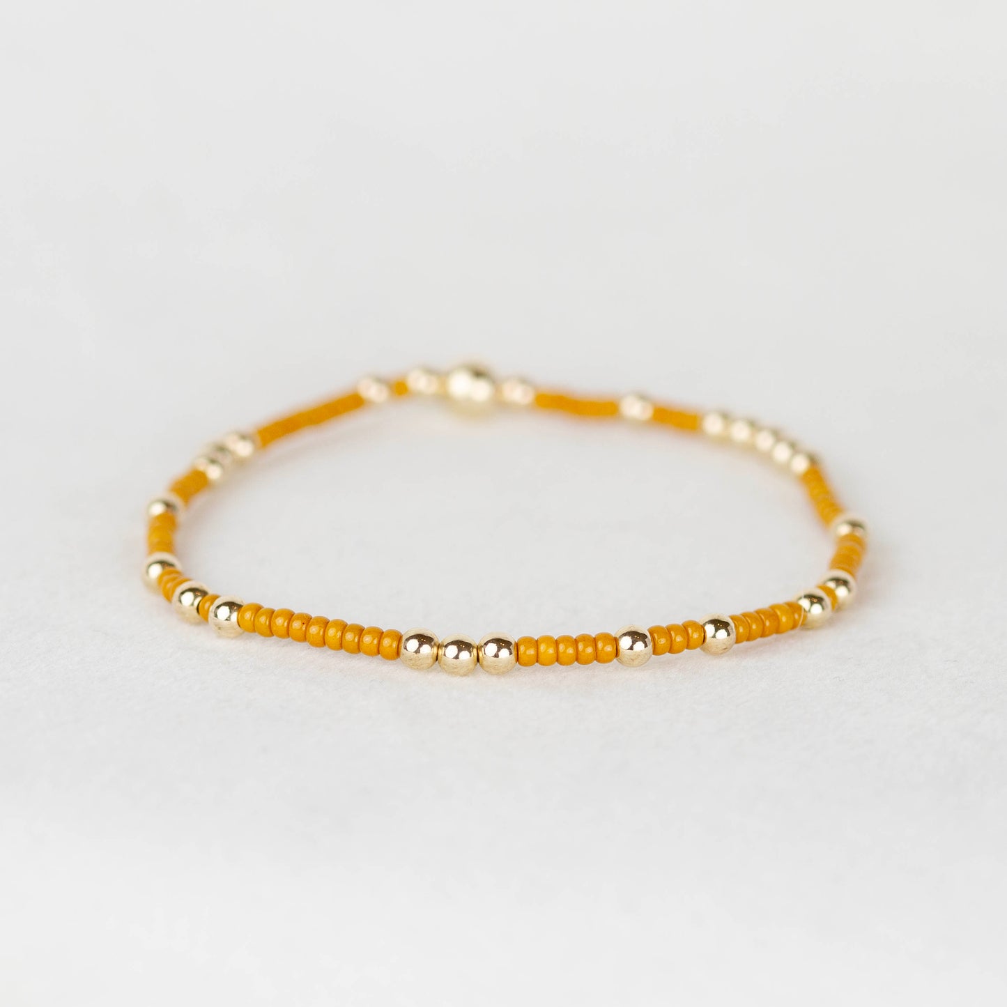 Mustard yellow Olivia seed bead with scattered 14k gold filled or sterling silver beaded stretch bracelet 