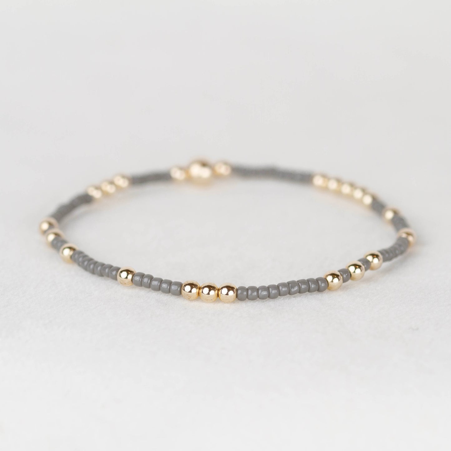 dark gray Olivia seed bead with scattered 14k gold filled or sterling silver beaded stretch bracelet 

