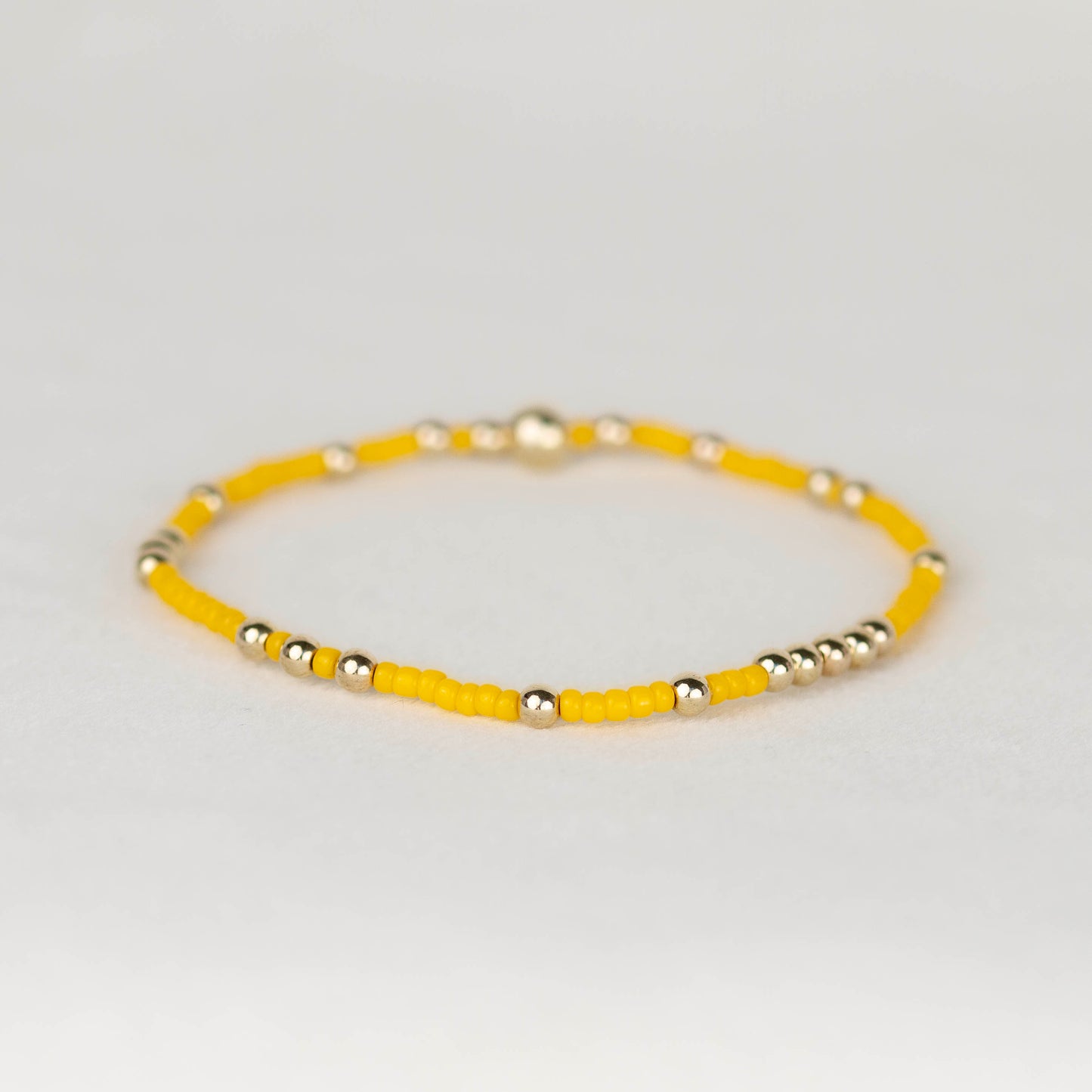 Dark Yellow Olivia seed bead with scattered 14k gold filled or sterling silver beaded stretch bracelet 