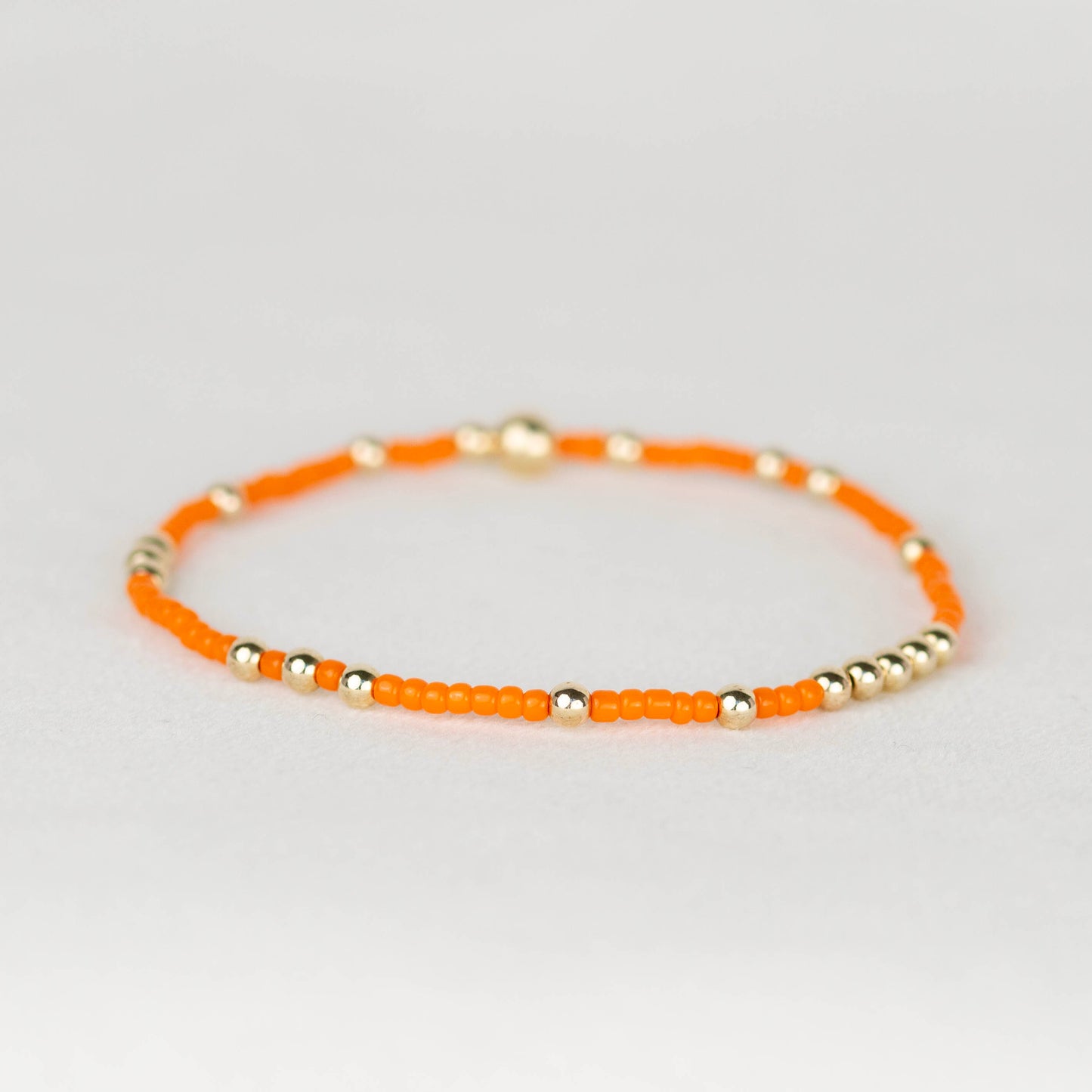 Bright Orange Olivia seed bead with scattered 14k gold filled or sterling silver beaded stretch bracelet 