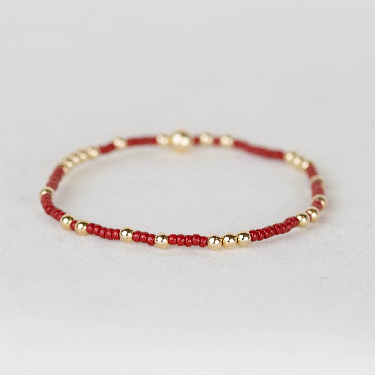 Dark red maroon Olivia seed bead with scattered 14k gold filled or sterling silver beaded stretch bracelet 