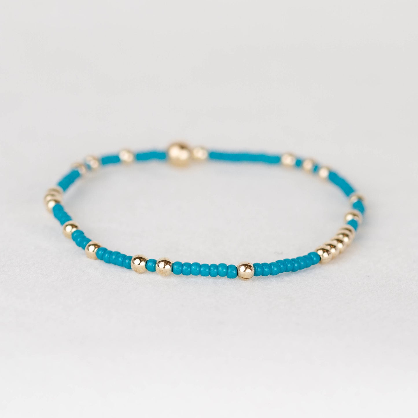 peacock teal Olivia seed bead with scattered 14k gold filled or sterling silver beaded stretch bracelet 