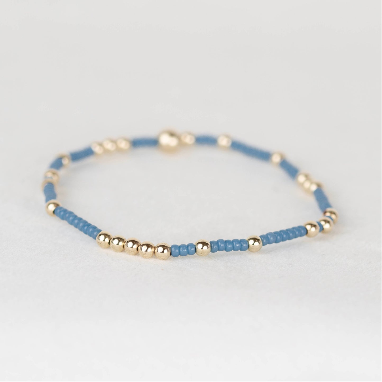 muted steel blue Olivia seed bead with scattered 14k gold filled or sterling silver beaded stretch bracelet 